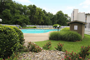 Kansas City townhouse for rent - A pool surrounded by a fence and bushes. at Willow Creek, Kansas City, 64114