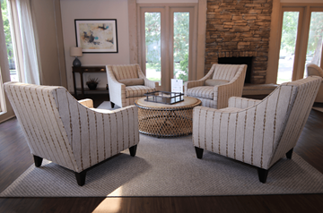 Overland Park townhouse for rent - Four striped chairs are arranged around a coffee table in a living room.