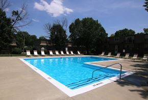 Olathe apartment for rent - A swimming pool with a white line on the edge and a metal railing.