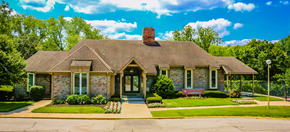 Kansas City townhouse for rent - a small brick house with a bench in front of it