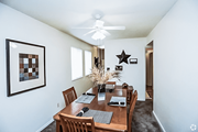 Kansas City townhouse for rent - a dining room with a wooden table and a ceiling fan at Gatehouse Apartments, Kansas City, MO, 64134
