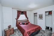 Kansas City townhouse for rent - a bedroom with a bed and a dresser and a window at Gatehouse Apartments, Missouri