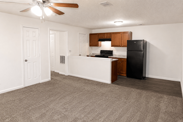 Shawnee apartment for rent - A kitchen with a black refrigerator and white countertops.