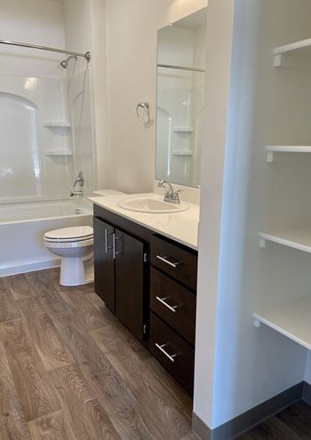 A bathroom with a toilet sink and bathtub