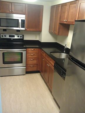 New Bedford apartment for rent - A kitchen with wooden cabinets and stainless steel appliances.