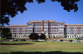 Mattapan apartment for rent - a large building with cars parked in front of it