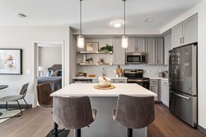 Brockton apartment for rent - A modern kitchen with a dining table and chairs.