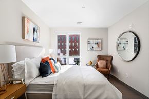 Brockton apartment for rent - A bedroom with a large bed and a chair.
