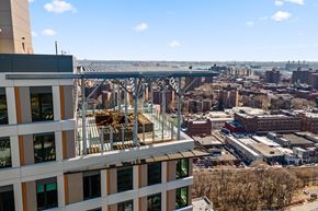 Bronx apartment for rent - an aerial view of a building with a balcony overlooking a city