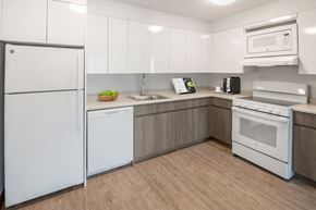 White Plains apartment for rent - a kitchen with white appliances and white cabinets
