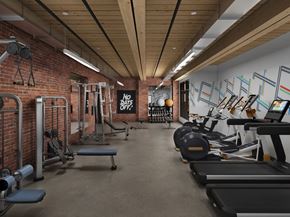 Lawrence apartment for rent - a gym with a brick wall and wood ceiling
