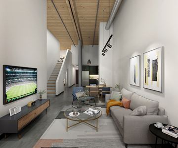 Lawrence apartment for rent - A modern living room with a grey couch, a coffee table, and a television displaying a soccer game.