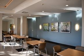 Bronx apartment for rent - a conference room with tables and chairs and pictures on the wall