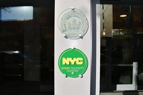 Bronx apartment for rent - the logo of the nyc green footprint corporation on the door of a building