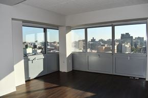 Bronx apartment for rent - an empty living room with a view of the city
