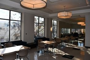 Bronx apartment for rent - a dining room with tables and chairs and large windows