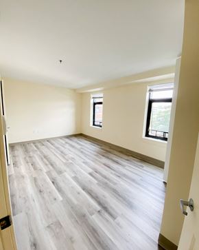 New Haven apartment for rent - the living room of a new home with wood flooring and a window