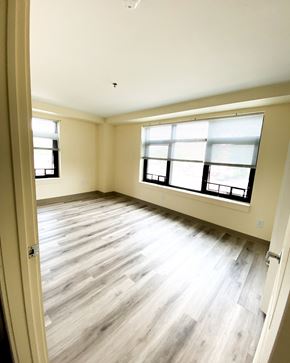 New Haven apartment for rent - an empty living room with wood floors and two windows