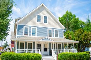 Dorchester townhouse for rent - a blue house with a white porch and blue siding