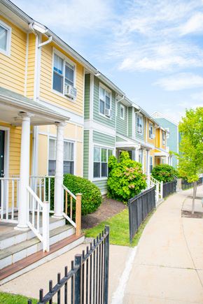 Roxbury apartment for rent - a row of townhomes with yellow and green siding