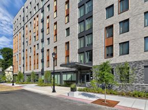 White Plains apartment for rent - A modern building with a grey and orange facade.