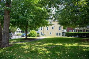 Dorchester townhouse for rent - a grassy area with trees and buildings in the background