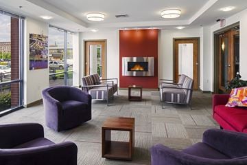 Brockton apartment for rent - A living room with purple chairs and a red couch.