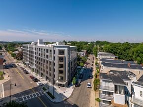 Dorchester apartment for rent - A city street with cars and buildings on a sunny day.