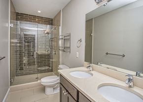 Boston apartment for rent - a bathroom with a shower toilet and sink and a mirror
