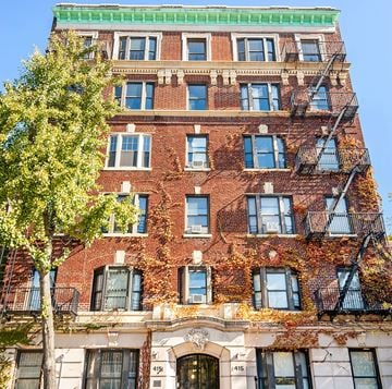 Brooklyn apartment for rent - A red brick building with a tree in front of it.