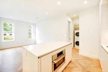 Brooklyn apartment for rent - A kitchen with a white counter top and wooden floors.
