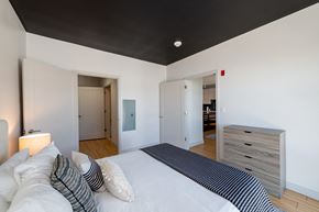 Boston apartment for rent - a bedroom with a white bed and a black ceiling