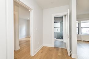 Somerville apartment for rent - a living room and bedroom with white walls and wood flooring
