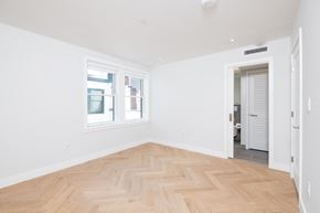Boston apartment for rent - a bedroom with a hardwood floor and two windows