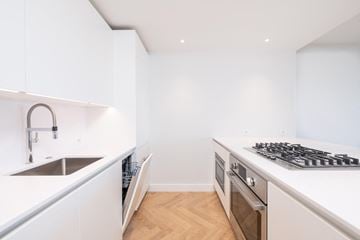 Boston apartment for rent - a white kitchen with stainless steel appliances and a sink