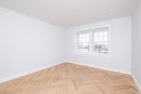 Boston apartment for rent - a bedroom with a wooden floor and a window