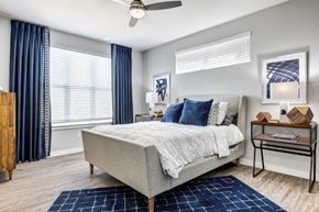 Kyle apartment for rent - a bedroom with a bed and a ceiling fan