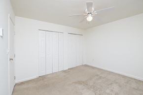 Quincy apartment for rent - a bedroom with two closets and a ceiling fan