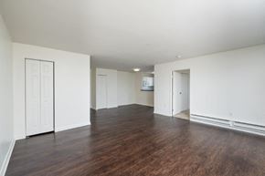 Quincy apartment for rent - an empty living room with white walls and wood floors