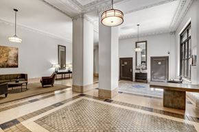 Manhattan apartment for rent - A large room with a tiled floor and a row of chairs.