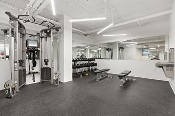 New York apartment for rent - A gym with a variety of equipment including weights and a bench.