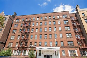 Brooklyn apartment for rent - A red brick building with a white door and windows.