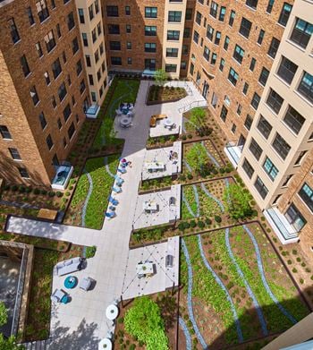 Landscaped courtyard with grills and lounge areas