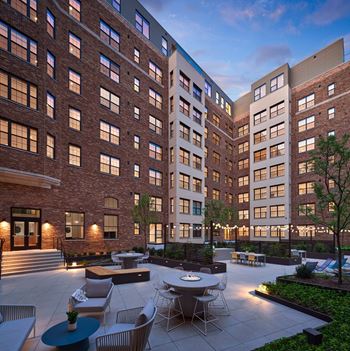 Landscaped courtyard with grills and lounge areas