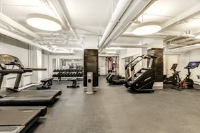 Manhattan apartment for rent - A spacious gym with treadmills, elliptical machines, and other exercise equipment.