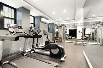 Manhattan apartment for rent - A spacious gym with treadmills, elliptical machines, and other exercise equipment.