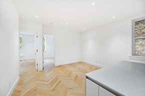 Brooklyn apartment for rent - A room with a wooden floor and white walls.