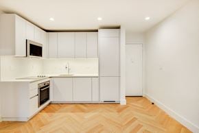 Brooklyn apartment for rent - A kitchen with white cabinets and a microwave on the counter.
