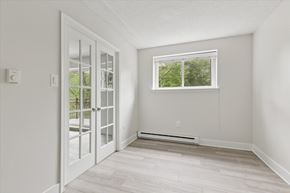 Warrington apartment for rent - A room with a window and a door leading to a balcony.