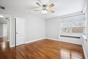 Philadelphia apartment for rent - A room with a ceiling fan and wooden floors.